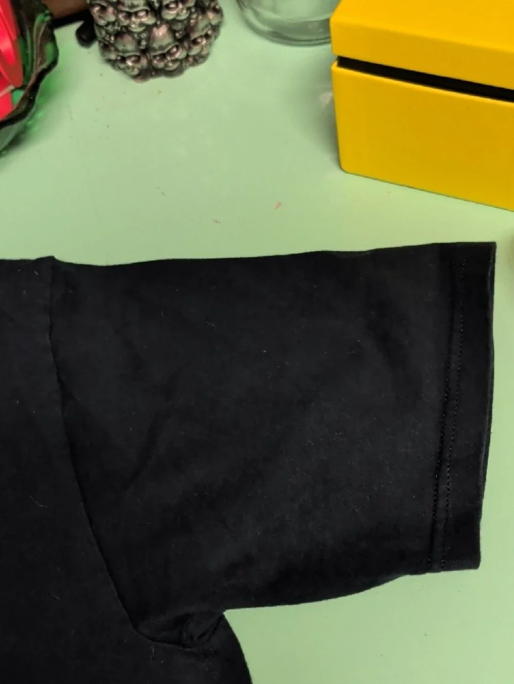 Supreme Black T-Shirt with Blue and Yellow Shield Graphic